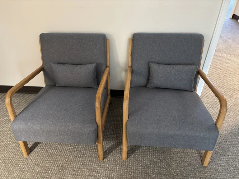 Pair of comfortable wood-armed chairs in the Littleton couples counseling office